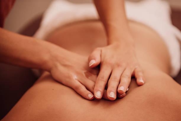 woman getting a back massage at a spa 
Photo taken indoors with stobe light